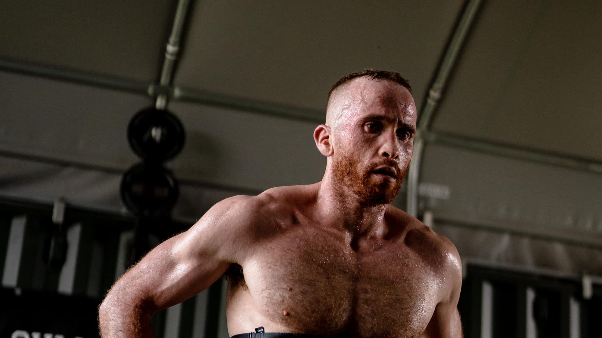 Ben Sutherland resting between sets inside the camp gym