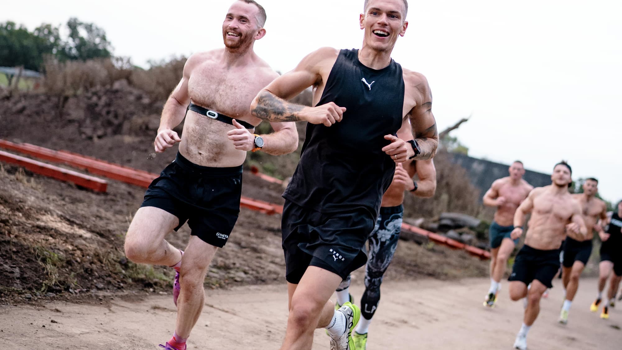 A group running together on a gravel track at a training camp