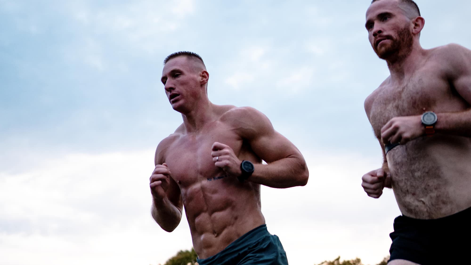 Two athletes running together at dawn