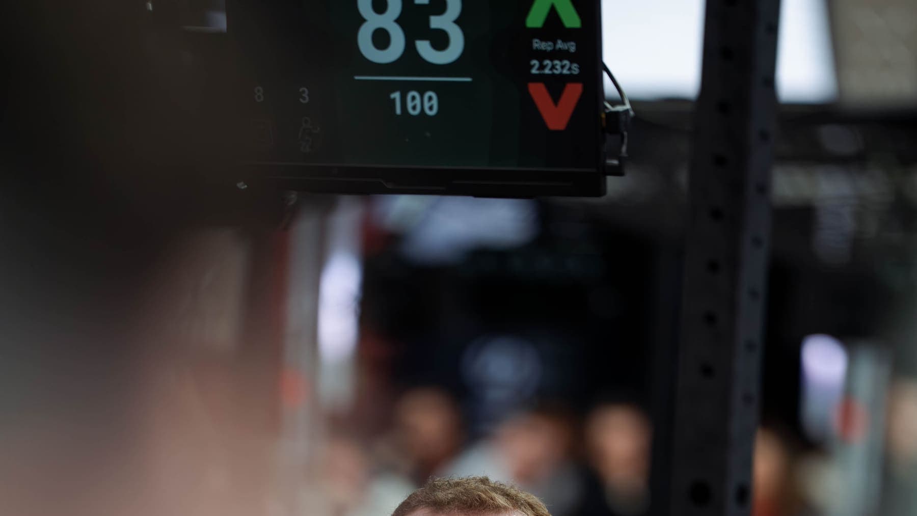 An athlete head on in front of the scoreboard