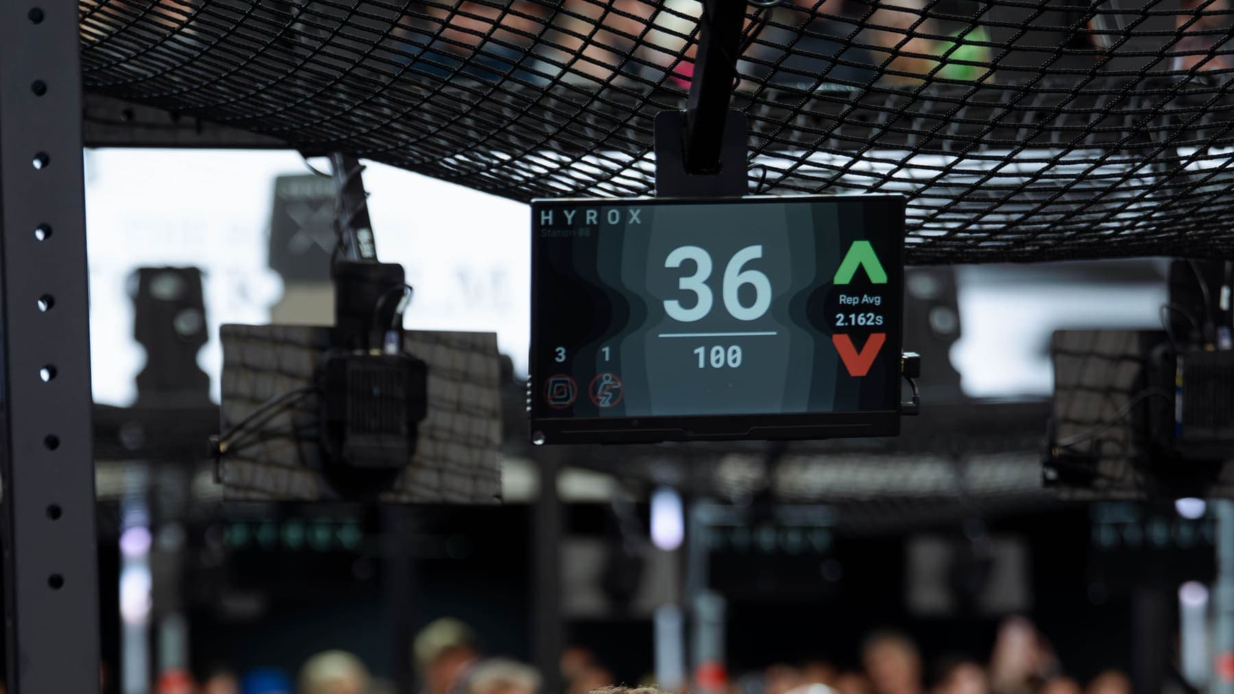 An athlete in front of the event scoreboard