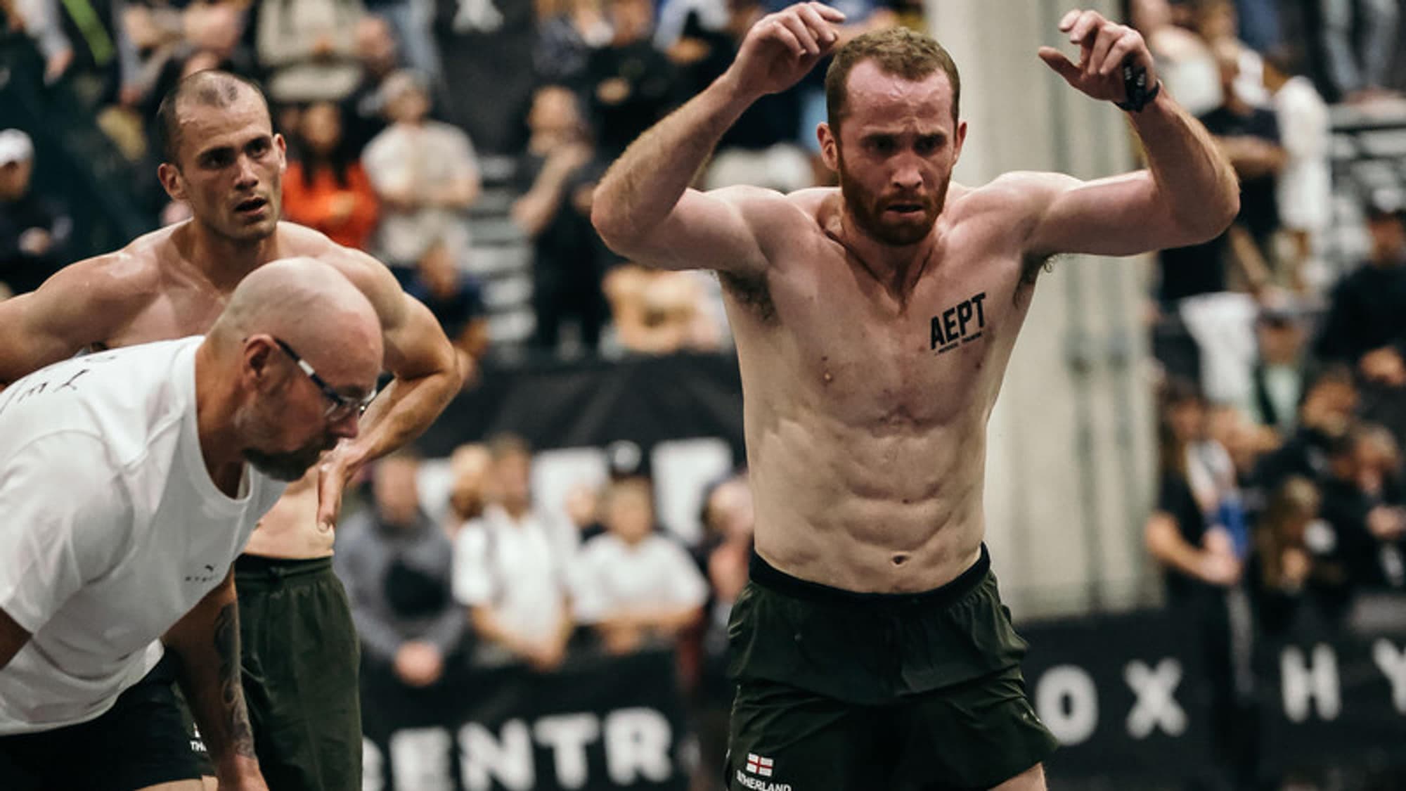 Judges watching an athlete work down the burpee broad jump lane