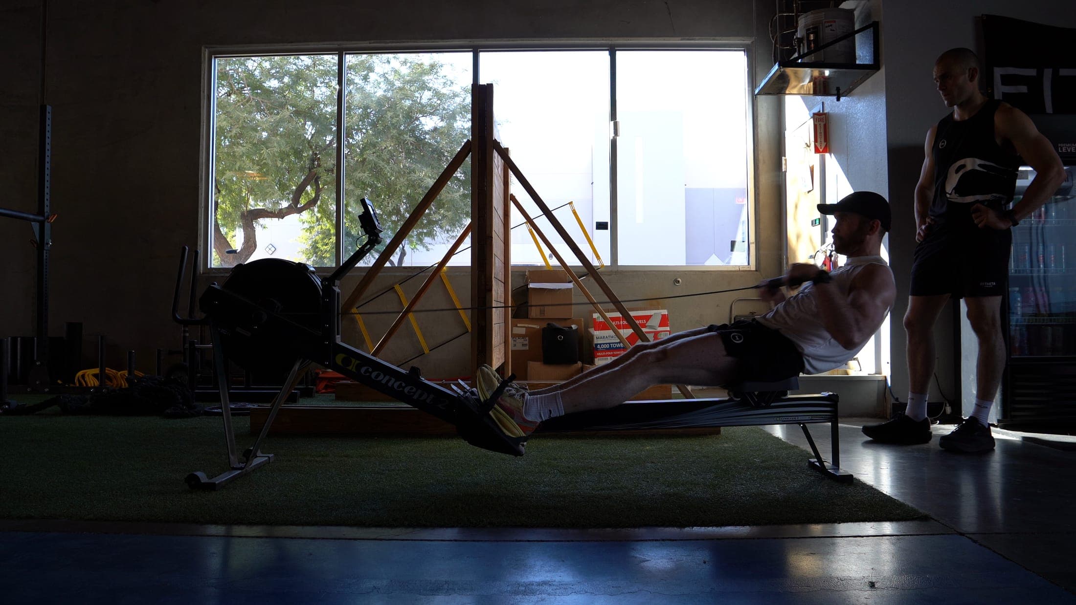 A coach watching an athlete work through a station