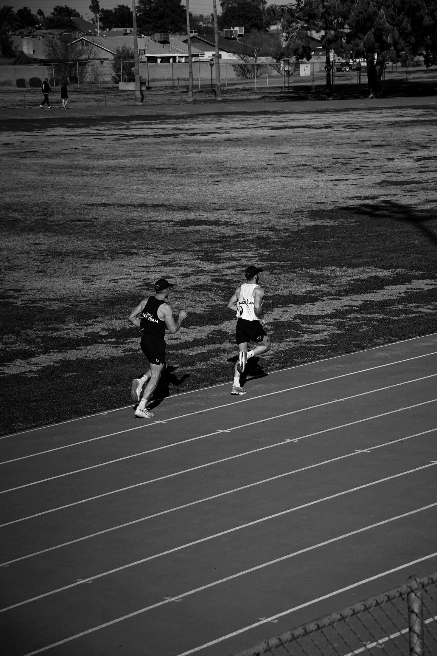 Two athletes working through a bend on a marked training lane