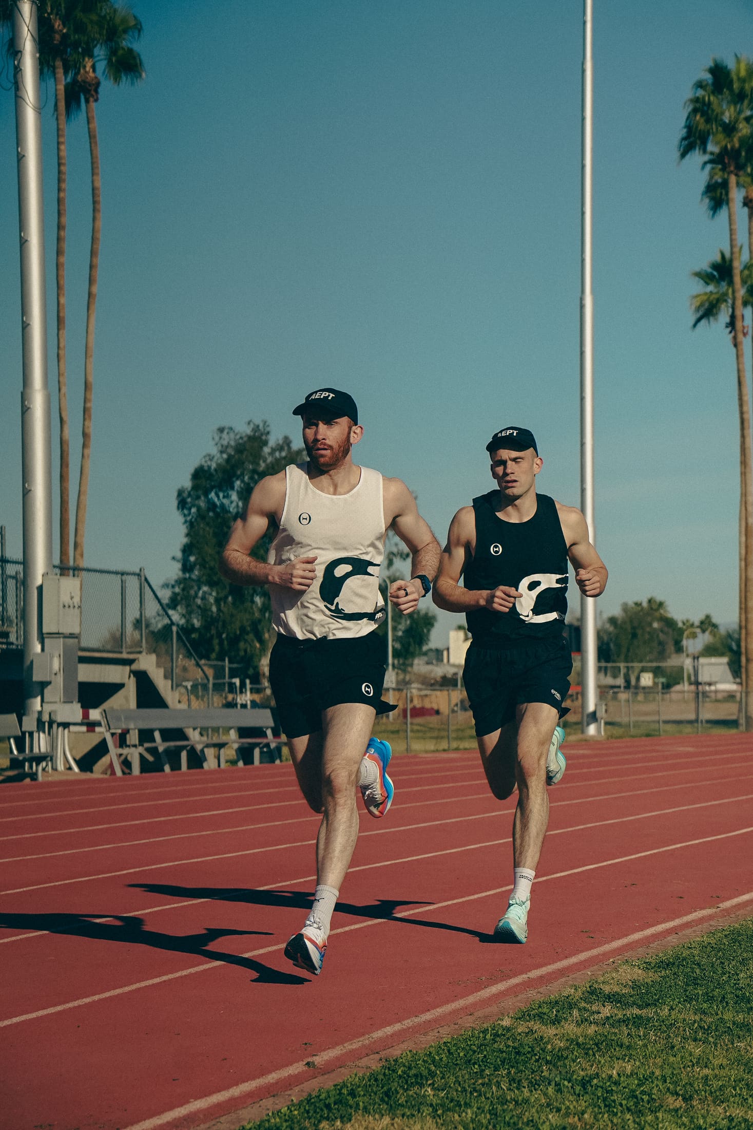 Ben and Harry Sutherland running side by side on the track